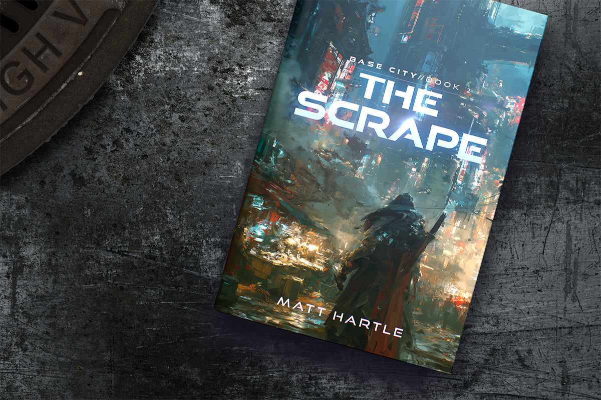 The Scrape paperback on a table, Base City Book 2 by Matt Hartle
